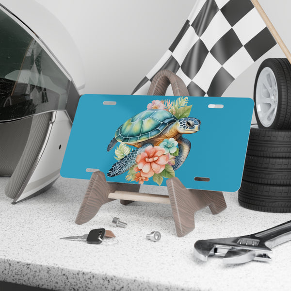 Blue license plate with a turtle design on a stand, surrounded by tools and tires.
