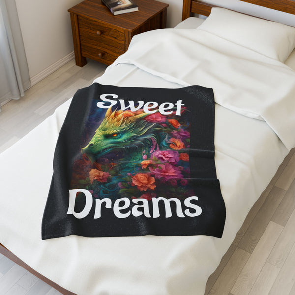 Colorful dragon design blanket with 'Sweet Dreams' text on a bed