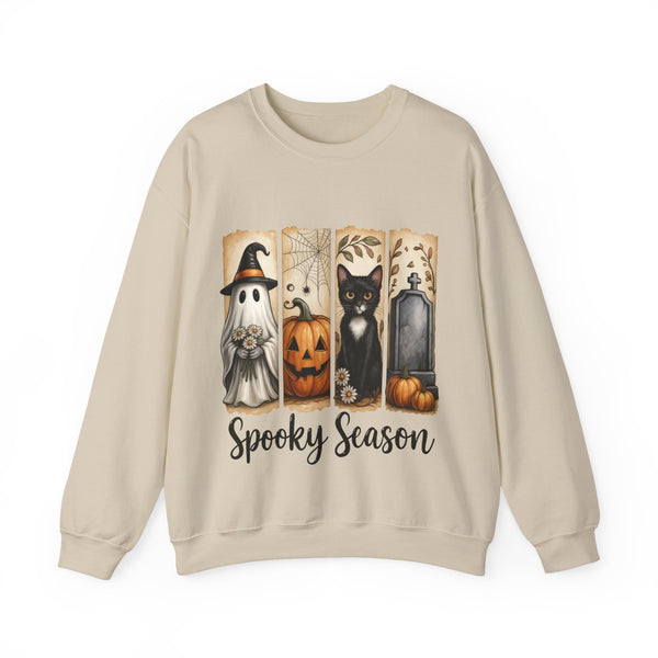 Beige sweatshirt with Halloween-themed design featuring ghost, pumpkin, cat, and tombstone on a white background.