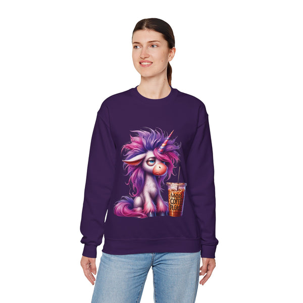 Person wearing a purple sweatshirt with a colorful creature design holding a coffee cup.