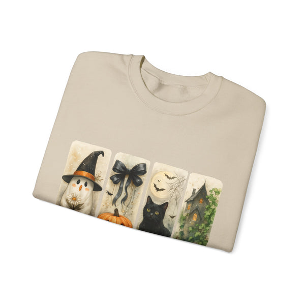 Folded beige sweatshirt with Halloween-themed design on a white background
