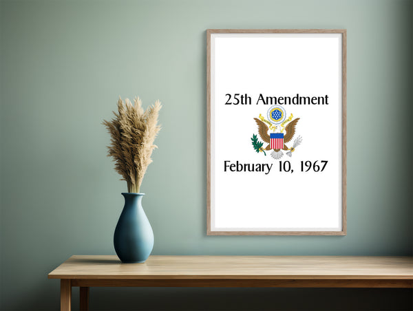 Framed poster of the 25th Amendment with a vase and decorative elements on a wooden table against a green wall.
