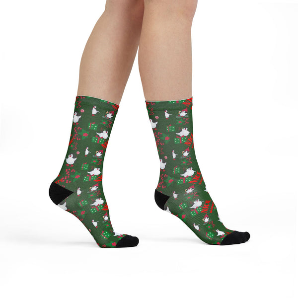 Green socks with animal pattern worn by a person on a white background