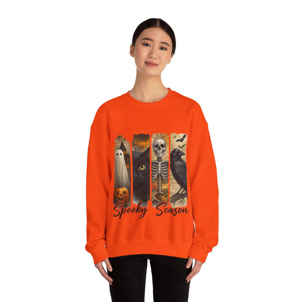 Person wearing an orange sweatshirt with Halloween-themed design and 'Spooky Season' text.