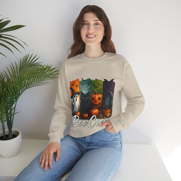 Woman wearing a beige sweatshirt with Halloween-themed design sitting on a white surface.