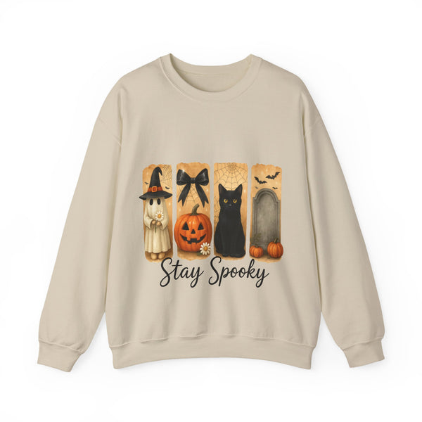 Beige sweatshirt with Halloween-themed design featuring a black cat, pumpkin, and witch on a white background.