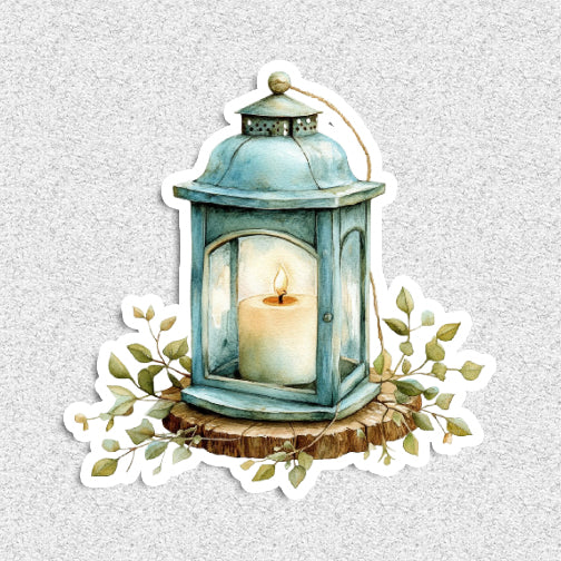 Decorative lantern with a candle and leaves on a textured gray background
