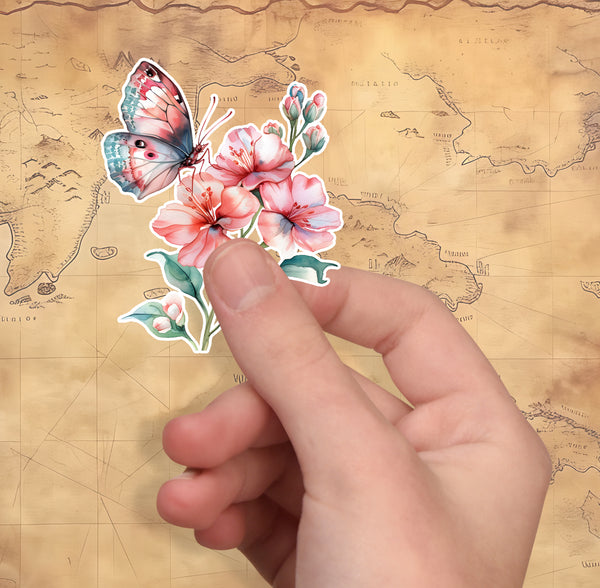 Hand holding a sticker of a butterfly and flowers on a vintage map background