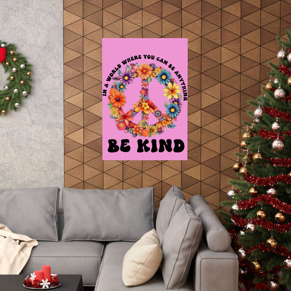 Living room with a pink poster featuring a peace symbol and flowers, a gray sofa, and Christmas trees.