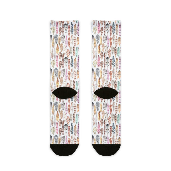 Pair of socks with feather pattern on a white background