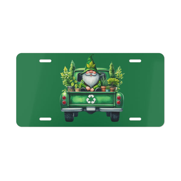 Green license plate with a gnome driving a truck carrying plants on a white background
