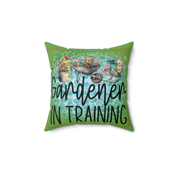 Decorative pillow with 'Gardener in Training' text and gardening-themed graphics on a white background.