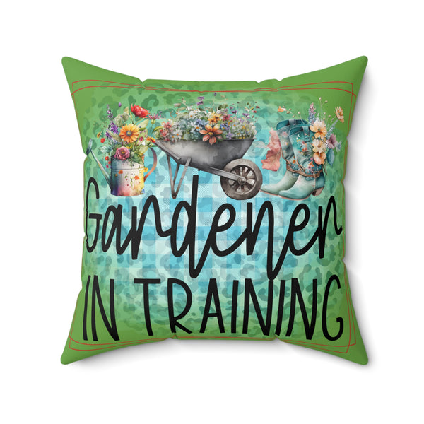 Decorative pillow with 'Gardener in Training' text and gardening-themed graphics on a green background.