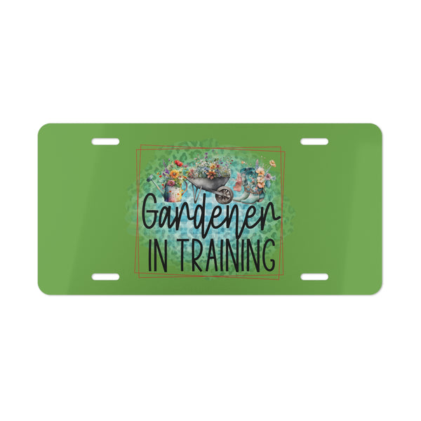 Green license plate with 'Gardener in Training' text and gardening-themed design on a white background