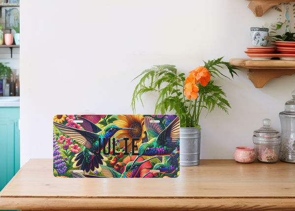 Personalized Hummingbird Custom Front License Plate Vanity Plate sitting a kitchen table with a vase of orange flowers 