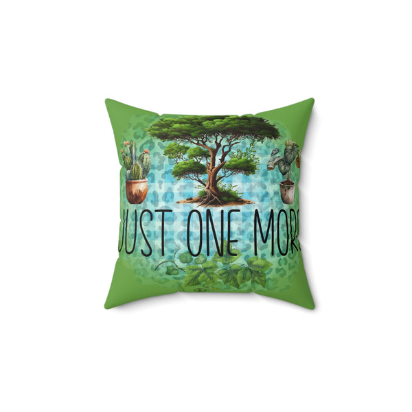 Decorative pillow with a tree and plants design and 'Just One More' text on a white background