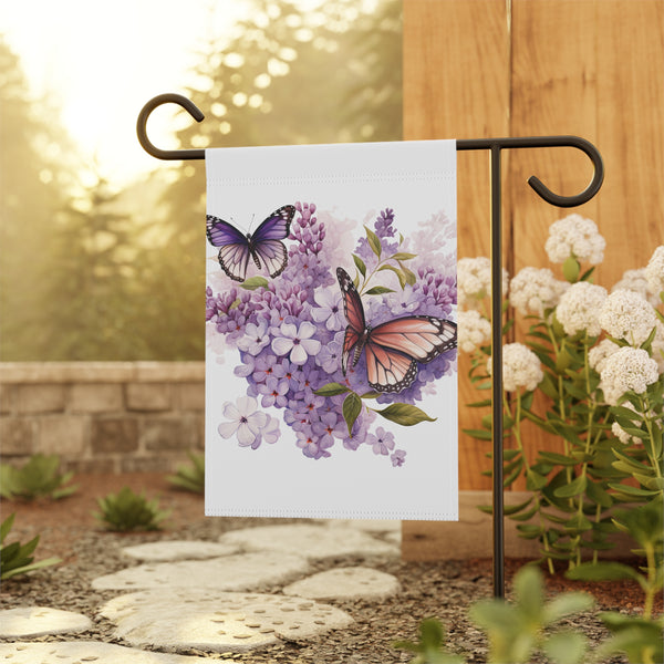 Decorative garden flag with butterflies and flowers on a stand outdoors.