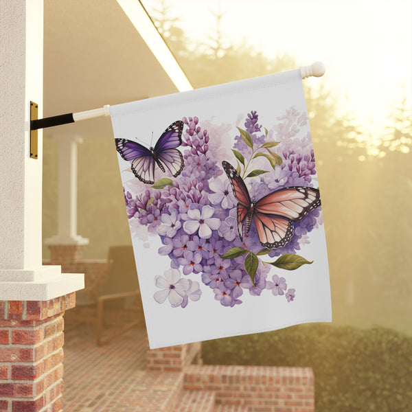 Decorative garden flag with butterflies and flowers on a pole against a blurred outdoor background.