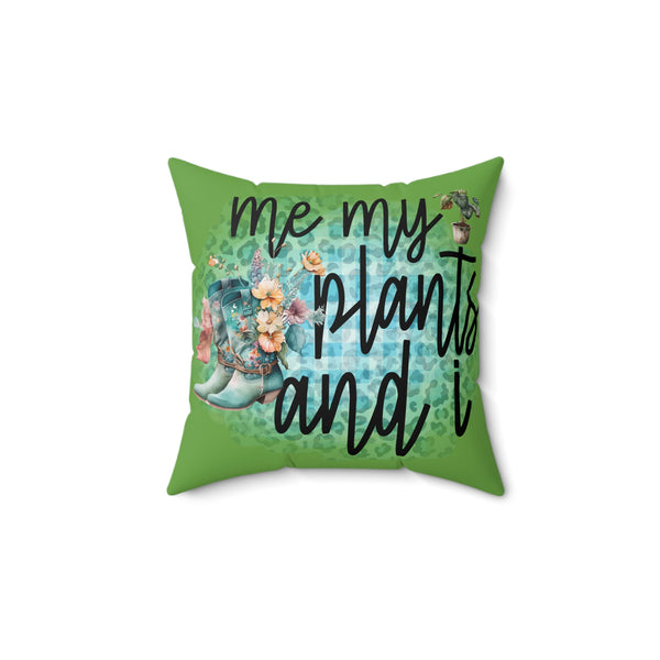 Green pillow with floral design and text 'me my plants and i' on a white background