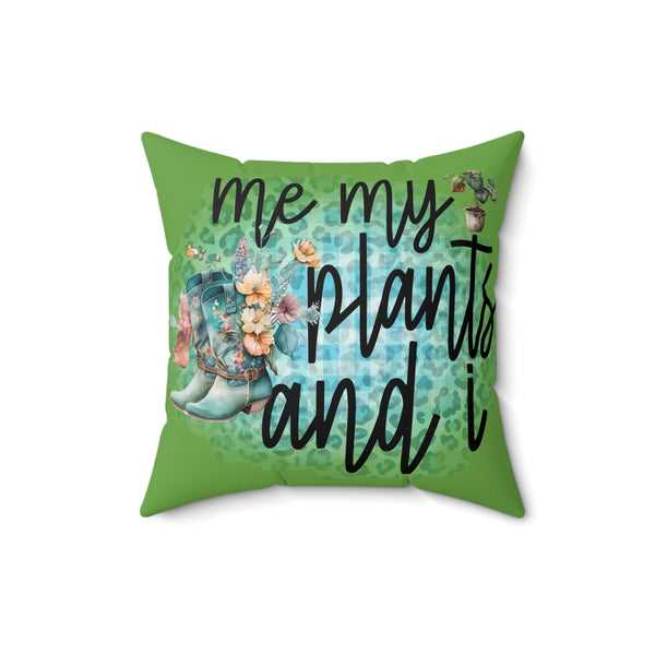 Green pillow with floral design and text 'me my plants and i' on a white background