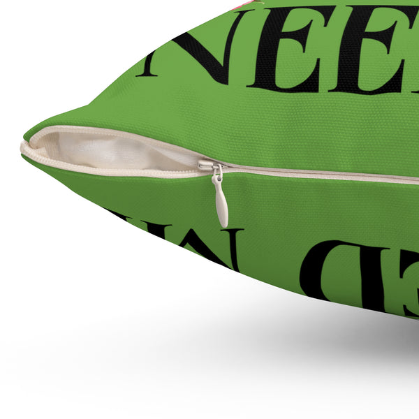 Green pillow with black text on a white background