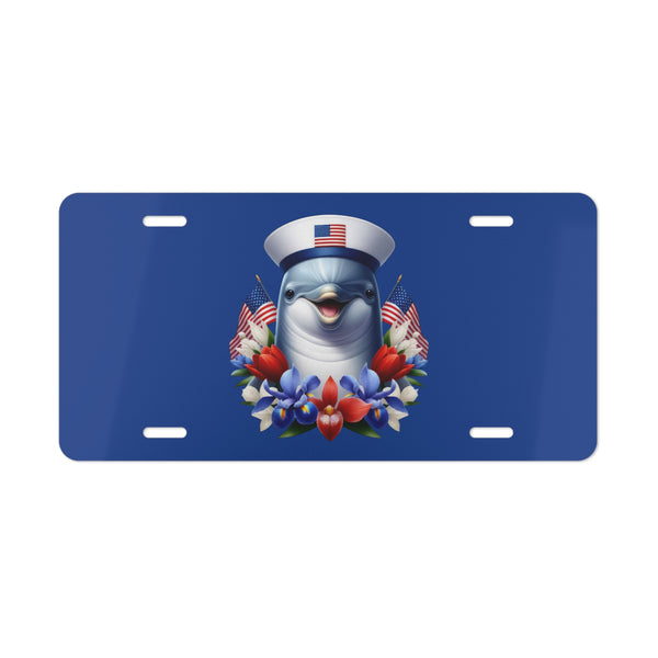 License plate with a dolphin wearing a sailor hat and surrounded by American flags and flowers on a blue background.