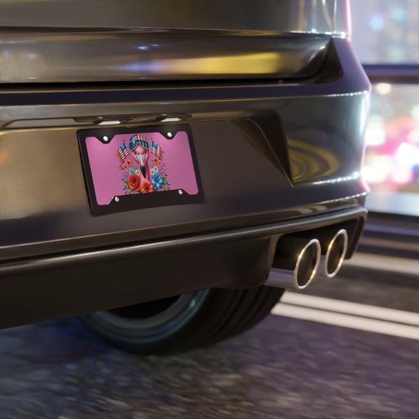 Car rear with a decorative license plate featuring flowers and a flag.