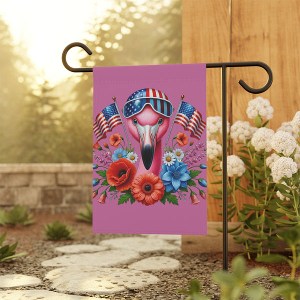 Decorative garden flag with a flamingo wearing sunglasses and American flags, displayed outdoors.