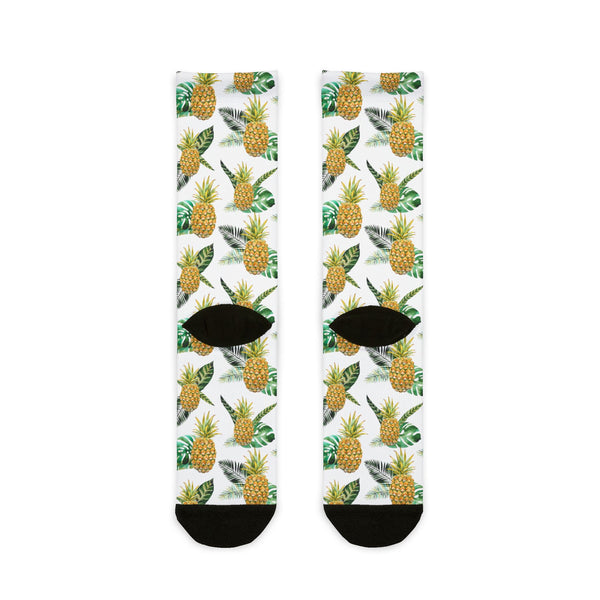 Two socks with pineapple and leaf pattern on a white background