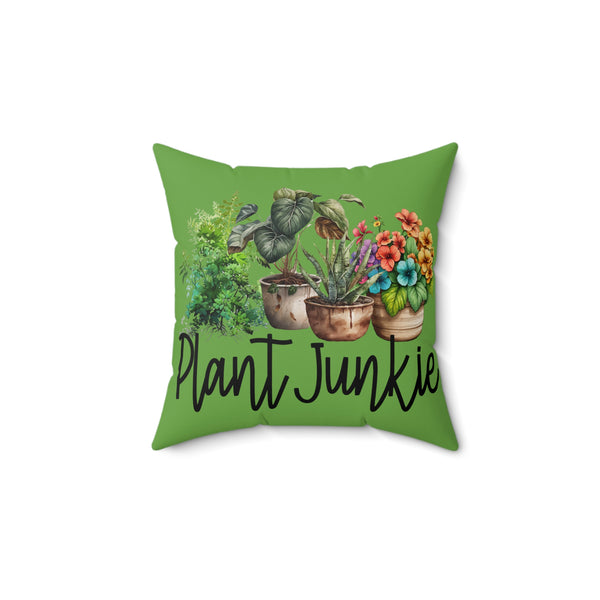 Green pillow with plant illustrations and 'Plant Junkie' text on a white background