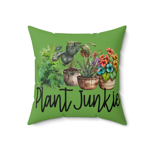 Green pillow with plant-themed design and 'Plant Junkie' text on a white background