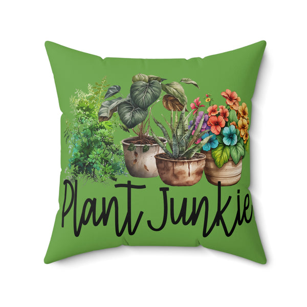 Green pillow with plant illustrations and 'Plant Junkie' text on a white background