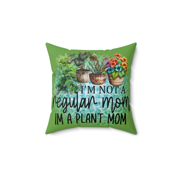 Green pillow with plant-themed design and text on a white background