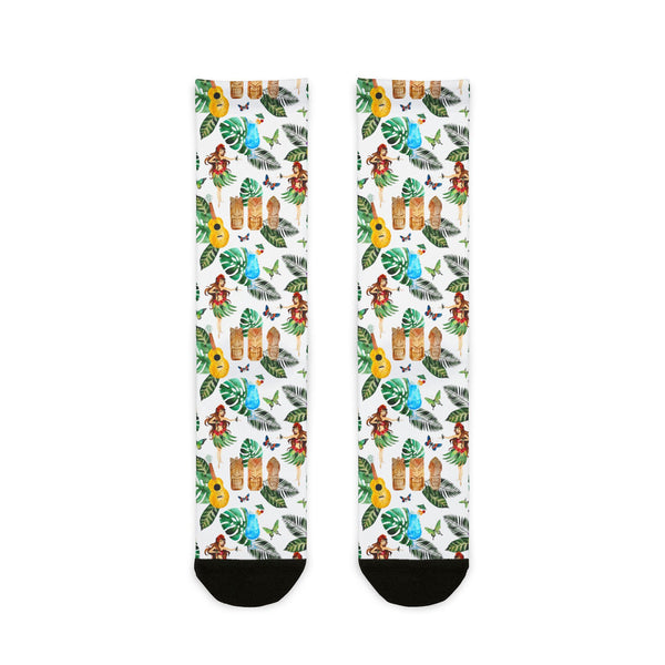 Tropical-themed socks with hula dancers, ukuleles, and leaves on a white background