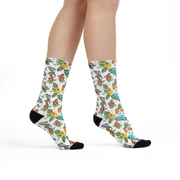 Socks with a tropical leaf pattern worn by a person on a white background