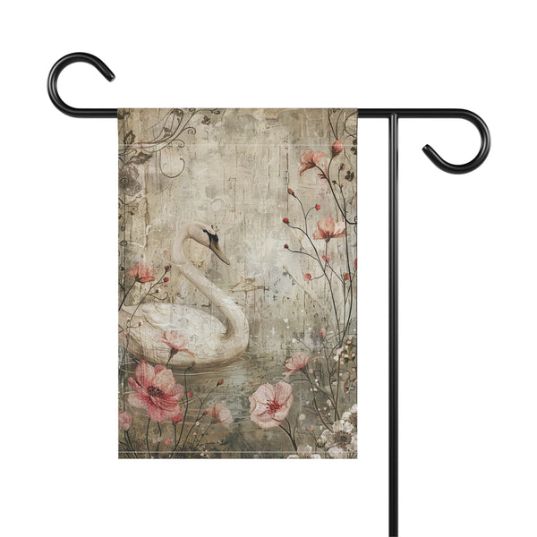 Decorative garden flag with a swan and floral design on a wooden background.